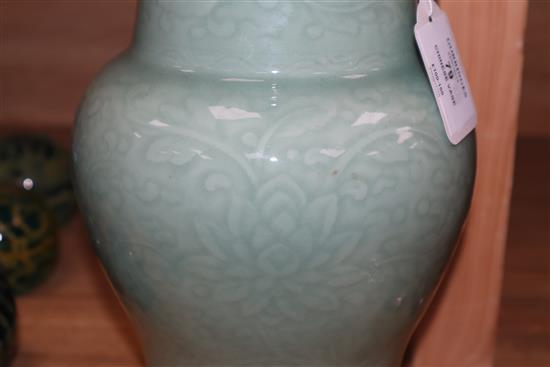 A Chinese Gu-shaped celadon vase, with floral decoration in relief and unglazed base, H 35.5cm